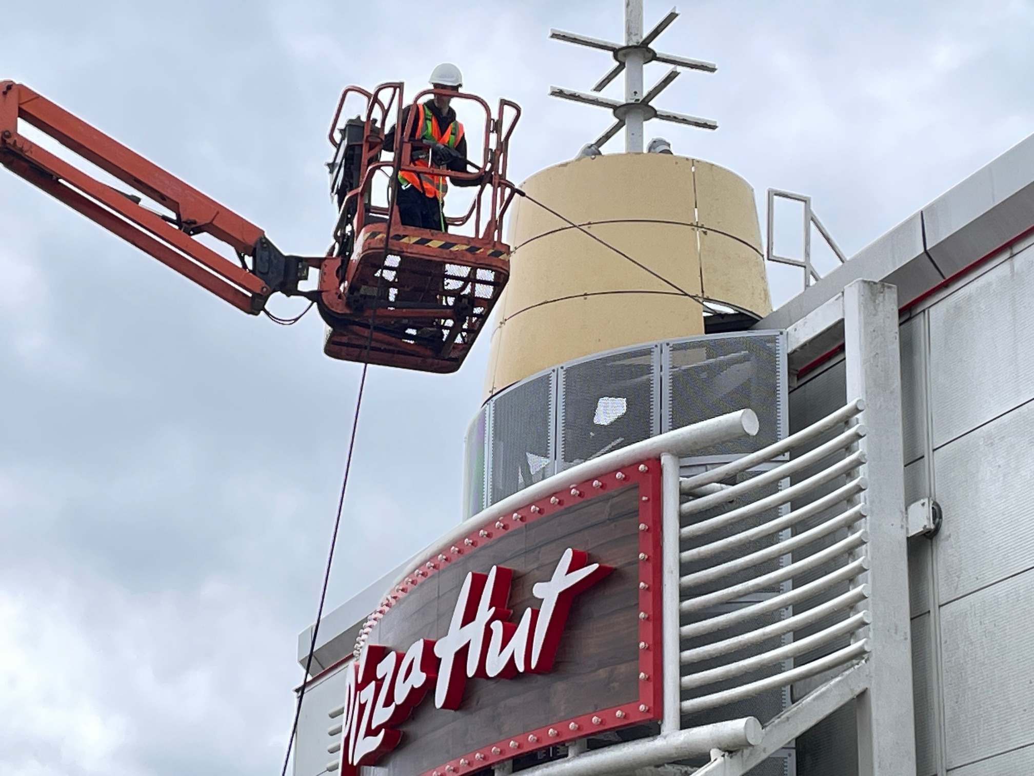 Kingdom Clear pressure washing a shopping-centre roof using an aerial work platform (cherry picker)